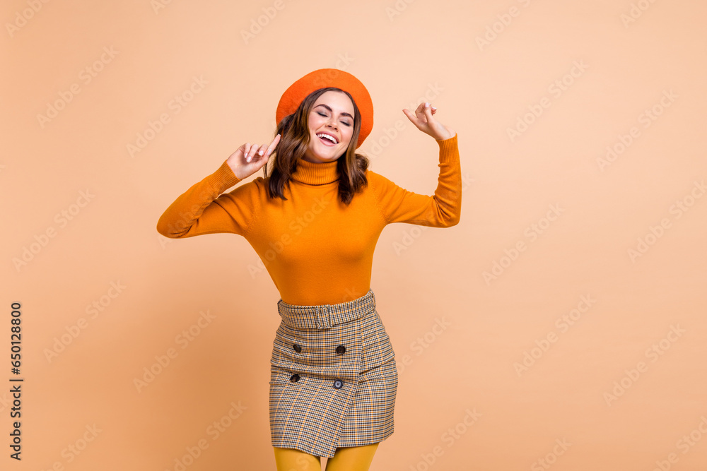 Photo of positive carefree crazy lady wear stylish orange outfit relax rest holiday weekend isolated on beige color background Photo of positive carefree crazy lady wear stylish orange outfit relax rest holiday weekend isolated on beige color background