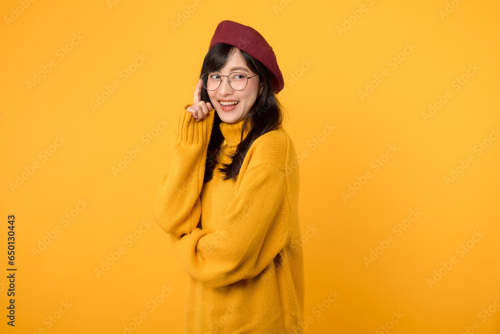 Portrait young asian woman 30s happy smile wearing yellow sweater and red beret showing thinking body language isolated on yellow background. Portrait young asian woman 30s happy smile wearing yellow sweater and red beret showing thinking body language isolated on yellow background.