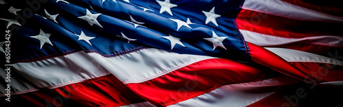 Bald Eagle and the American Flag blurred in the background. Stars and Stripes and concept of Patriotism and pride. Shallow field of view with copy space.