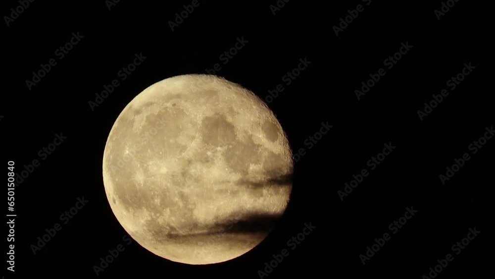 Full Moon is covered by flying natural black clouds, like in thrillers and horror films, in the style of Halloween. Cloudy dark night sky. Real shooting Full Moon is covered by flying natural black clouds, like in thrillers and horror films, in the style of Halloween. Cloudy dark night sky. Real shooting