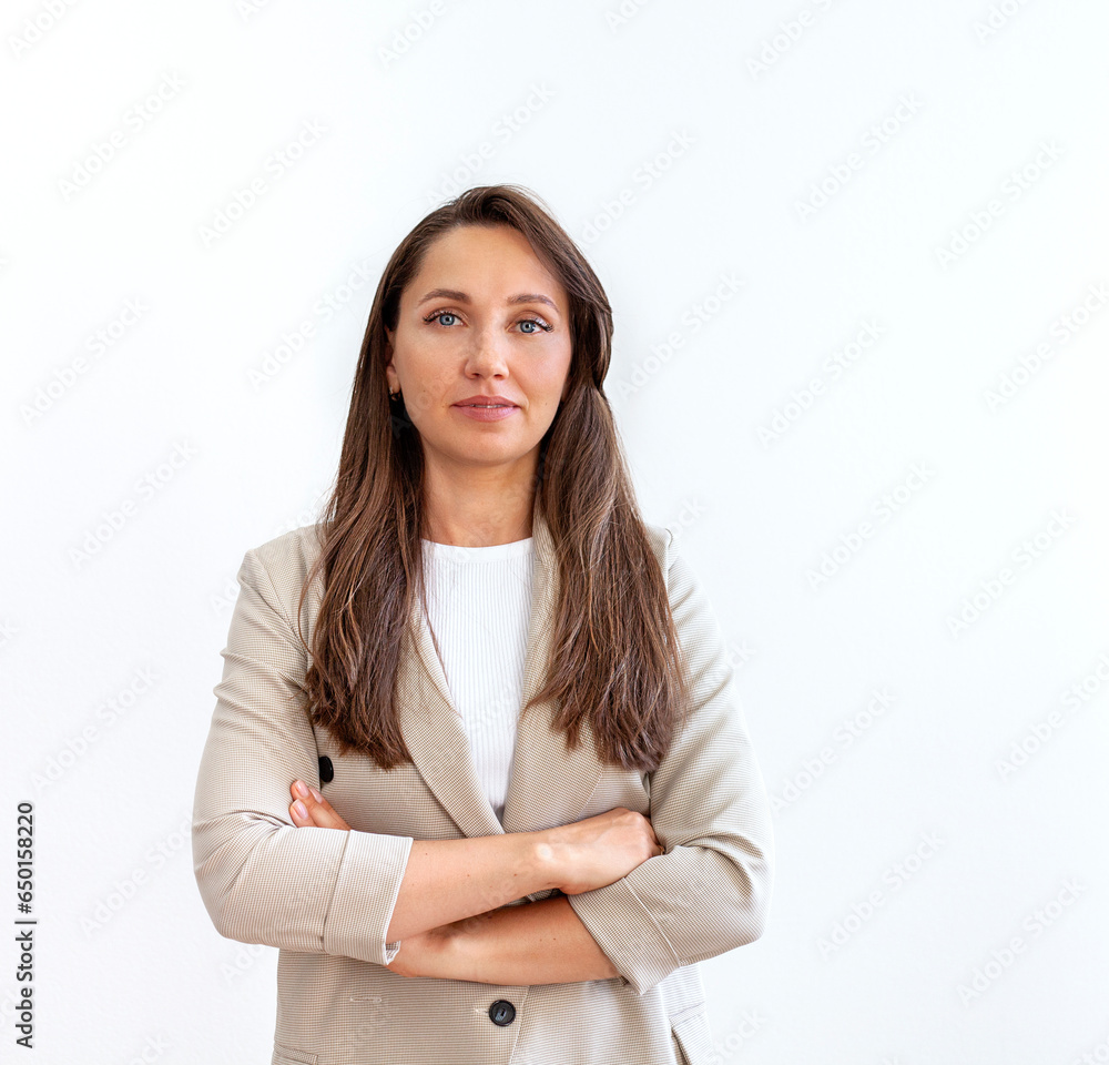 Portrait of a confident businesswoman standing with arms crossed against white background Portrait of a confident businesswoman standing with arms crossed against white background