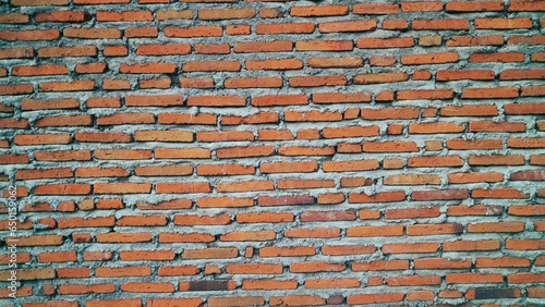 Unfinished red brick wall or tembok bata merah. Batu bata wall. Vintage wall background and texture.