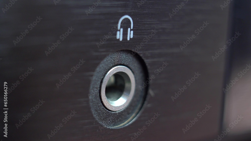 Connecting Headphones to Headphone Jack Slot in Stereo Set Close-Up Connecting Headphones to Headphone Jack Slot in Stereo Set Close-Up