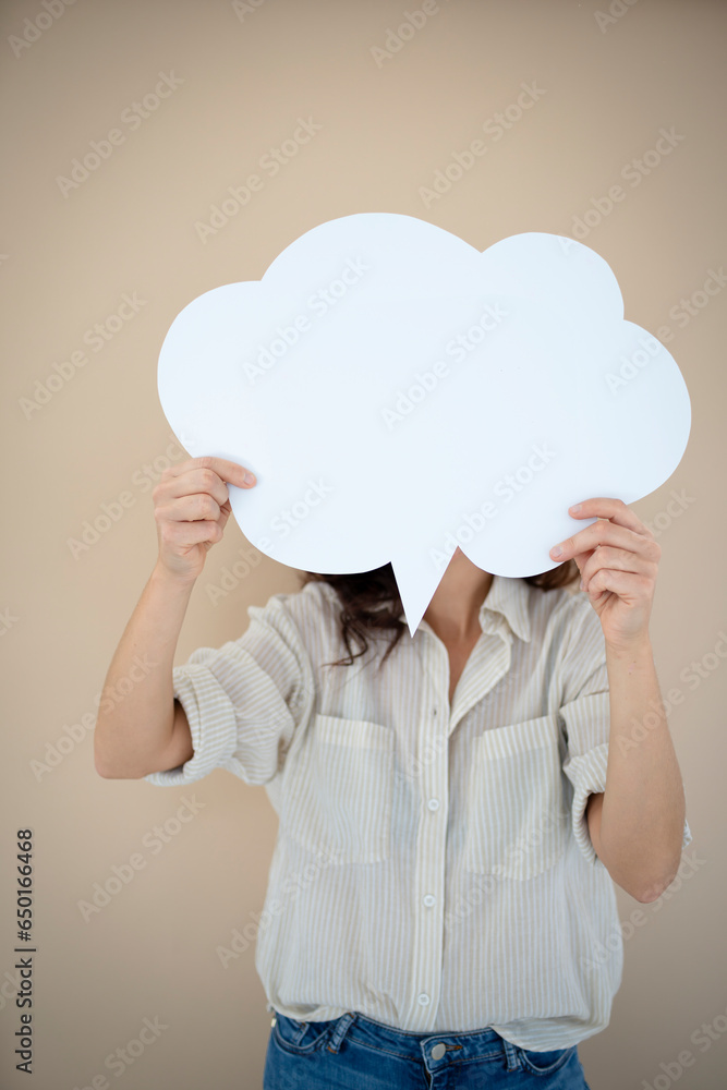 beautiful woman holding white speech bubble in front of brown background beautiful woman holding white speech bubble in front of brown background