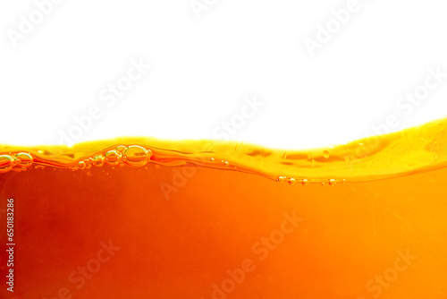 Orange liquid splash isolated on white background. Close up of orange liquid.