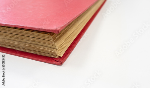 Close up of antique red book on white table. Copy space