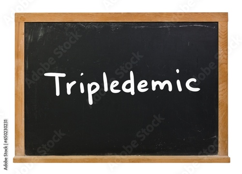 Tripledemic written in white chalk on a black chalkboard isolated on white
