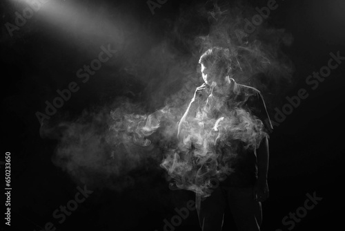a man smocking an electronic cigarette (ID: 650233650)
