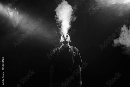 a man smocking an electronic cigarette (ID: 650233663)