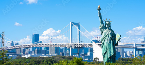 Tokyo, Japan. Odaiba, a popular tourist destination. A replica of the Statue of Liberty and the cityscape of Tokyo. photo