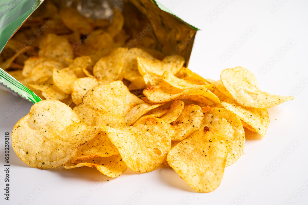 Potato chips, delicious spicy for crips, thin slice deep fried snack fast food in open bag. Potato chips, delicious spicy for crips, thin slice deep fried snack fast food in open bag.
