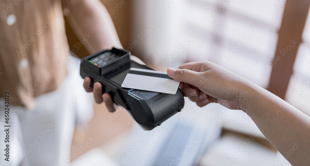 Contactless payment holding credit card with touch settlement paying for shopping nfc technology transaction cashless technology and credit card payment