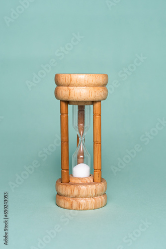 Hourglass, sand watch isolated on green background (ID: 650243053)