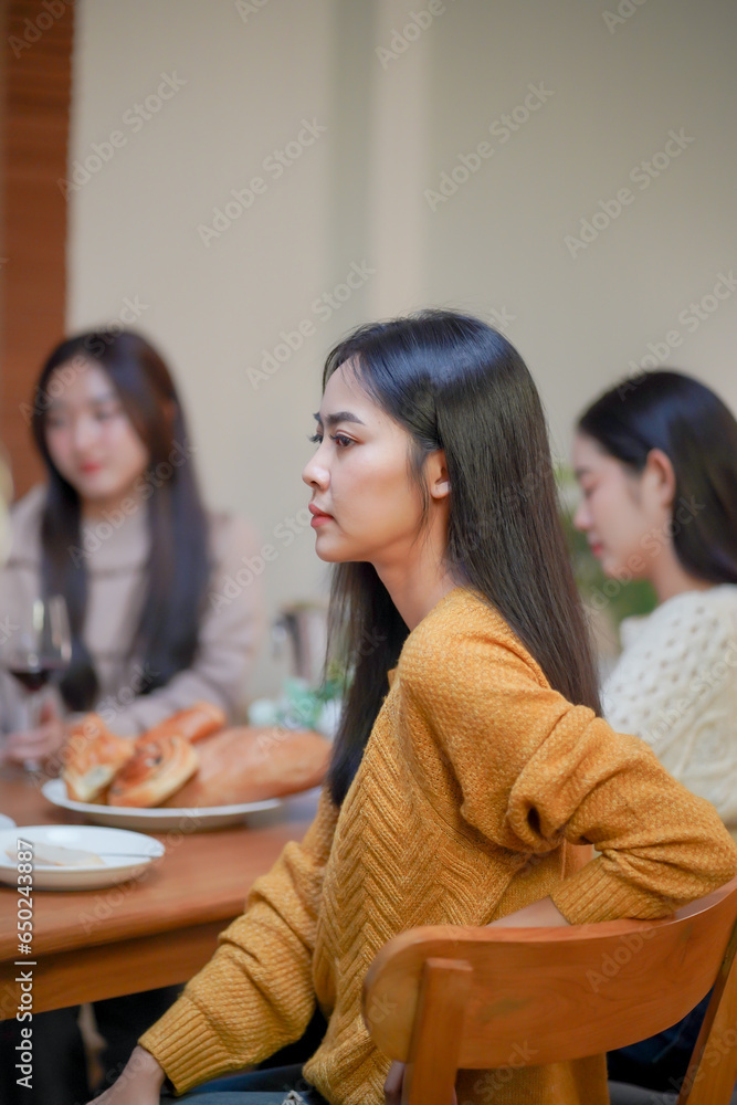 Cheerful friends enjoying home Birthday holiday party. Asian sister cheering drinking red wine celebrating with Birthday cake. Cheerful friends enjoying home Birthday holiday party. Asian sister cheering drinking red wine celebrating with Birthday cake.