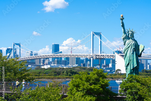 Tokyo, Japan. Odaiba, a popular tourist destination. A replica of the Statue of Liberty and the cityscape of Tokyo. photo
