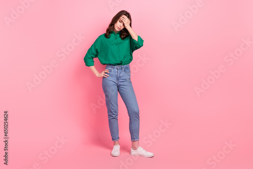 Full length photo of stressed tired woman dressed green shirt arm hand head empty space isolated pink color background