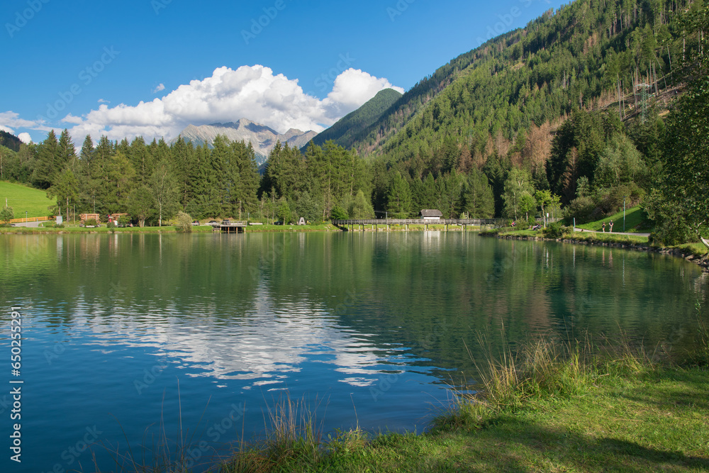 Panoramic view of alpine lake in the little village of Selva dei Molini, Zillertal alps, Italy