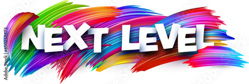 Next level paper word sign with colorful spectrum paint brush strokes over white.
