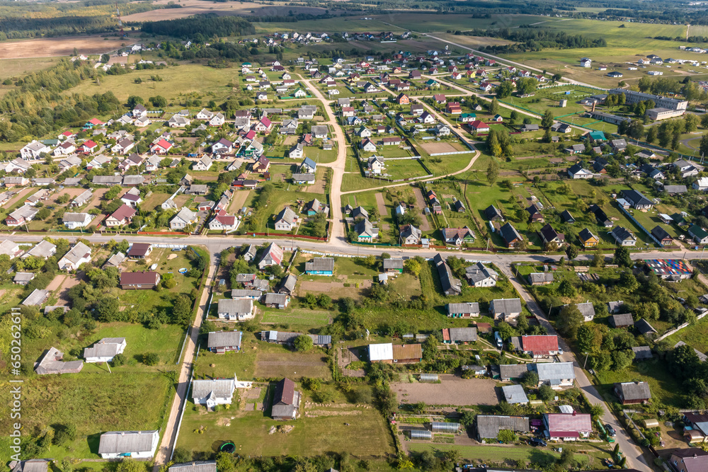 aerial view on provincial city or big village housing area with many buildings, roads and garden.