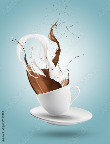 milk and chocolate splashing out of cup on blue background.