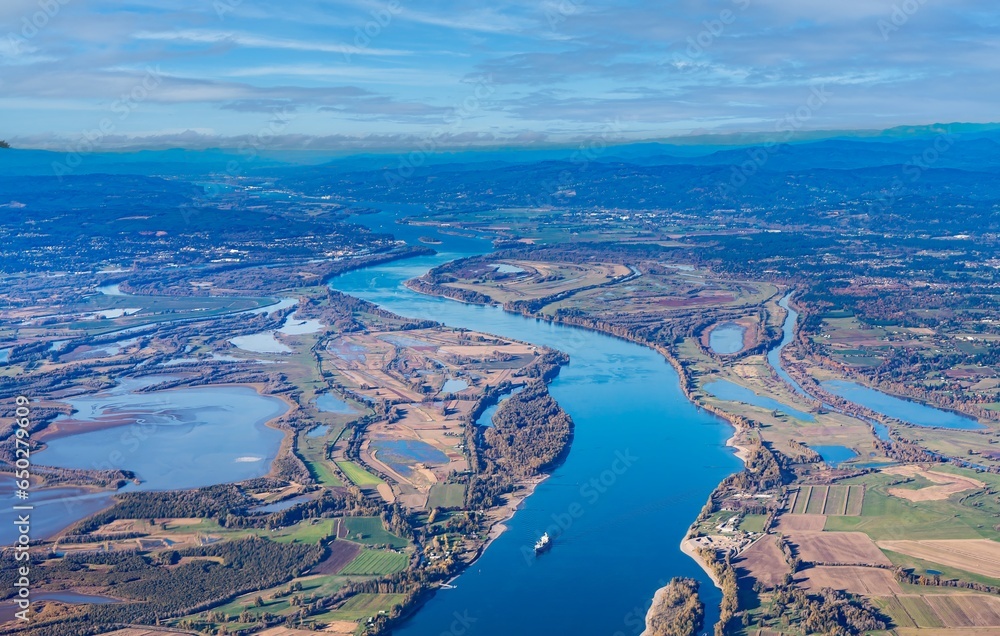 Obraz premium Aerial view of Sauvie island farm and wildlife area and the Columbia River leading west toward Astoria, Oregon, from Vancouver, Washington