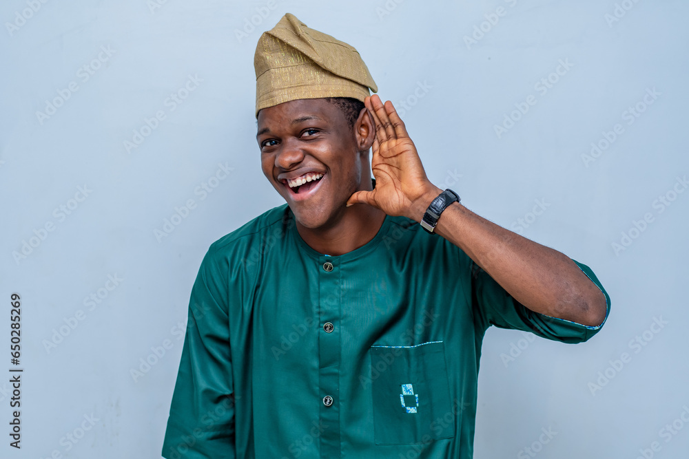 young african guy in native attire raising fists up celebrating success. African american millennial man sharing good emotions, copy space young african guy in native attire raising fists up celebrating success. African american millennial man sharing good emotions, copy space
