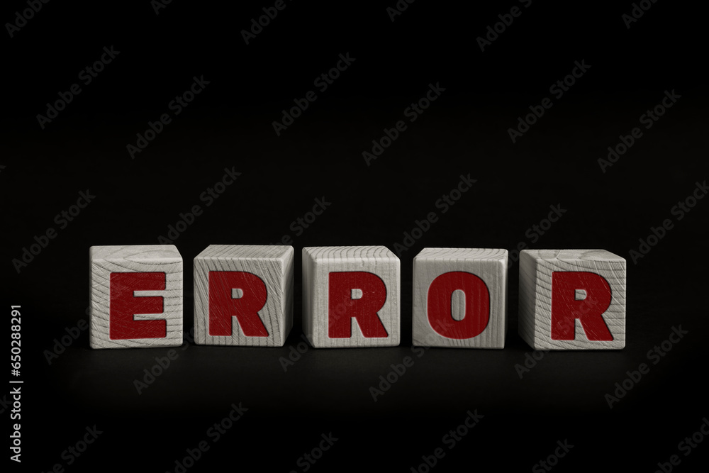Obraz premium Word ERROR written with wooden cubes. Studio shot of some arranged wooden blocks with a textual message.