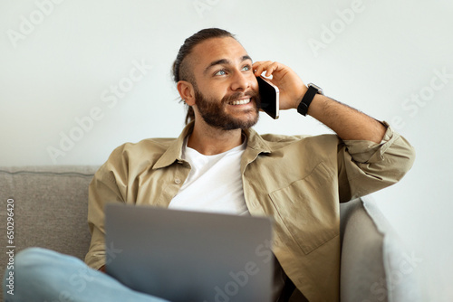 Wealthy young caucasian man entrepreneur working from home, using laptop