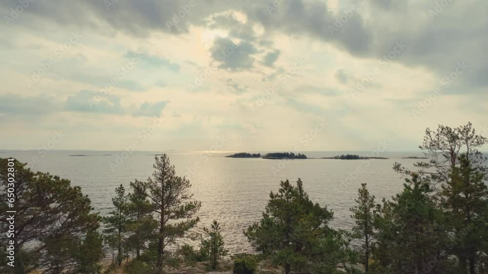 Russia, Karelia, Lake Ladoga, Koyonsaari. View of the coast of the island in a cold lake. Beautiful nature of the Republic of Karelia. Stunning panoramic view of the Ladoga Skerry Islands. 4K Russia, Karelia, Lake Ladoga, Koyonsaari. View of the coast of the island in a cold lake. Beautiful nature of the Republic of Karelia. Stunning panoramic view of the Ladoga Skerry Islands. 4K