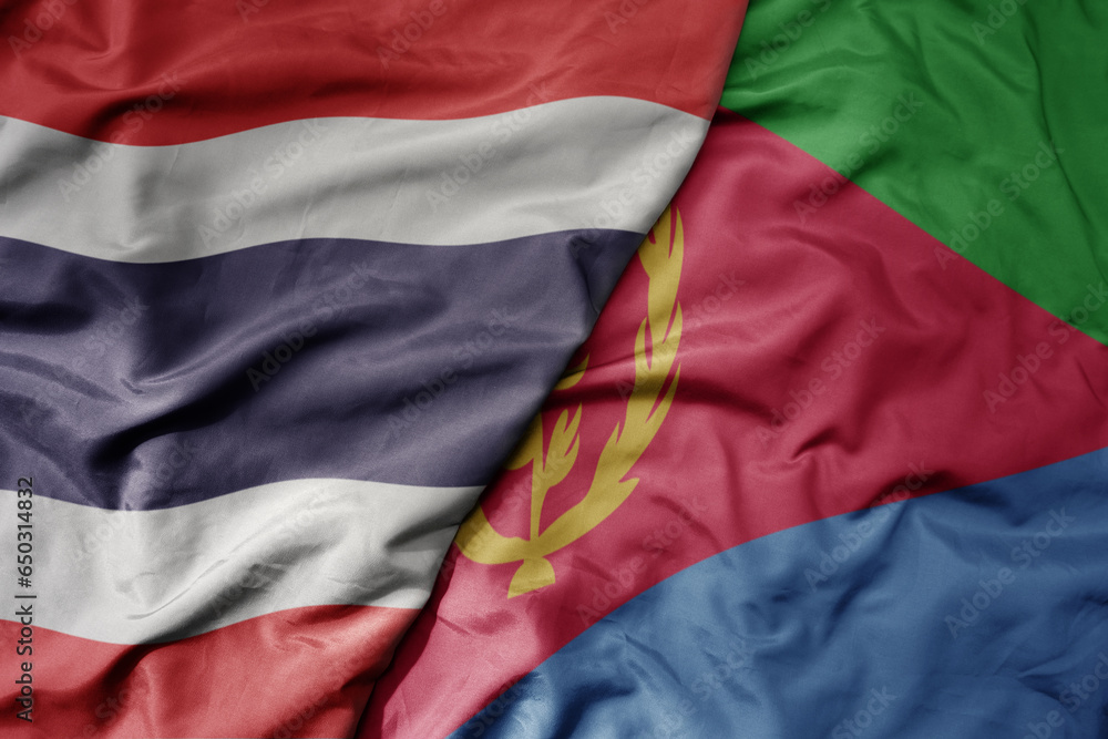 big waving national colorful flag of thailand and national flag of eritrea .