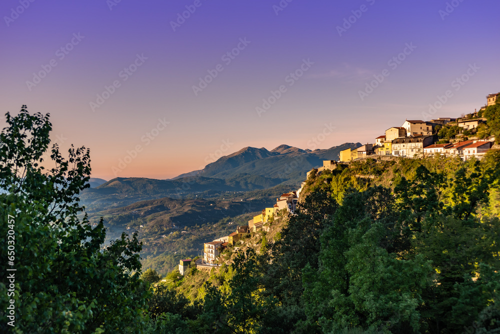 Panoramic View of A Small Town Perched On A Mountain In Basilicata, Southern Italy, At Sunrise On A Blurred Background