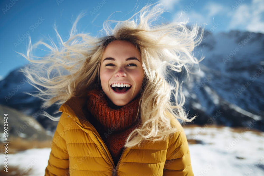 Portrait of young smiling woman with flying blonde hair in windy day standing at mountain - carefree woman Portrait of young smiling woman with flying blonde hair in windy day standing at mountain - carefree woman