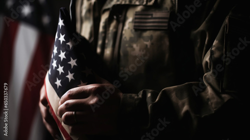 American flag held by a soldier.  © alexkich