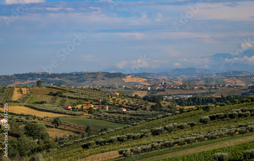 Beautiful landscape with countryside  mountain and cloudy sky  Marche region  Italy