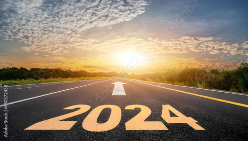New year 2024 or straightforward concept. Text 2024 written on road in the middle of asphalt road at sunset. Concept of planning and challenge, business strategy, opportunity, hope, new life change