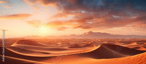 Aerial perspective of desert sand dunes during sunset © AkuAku