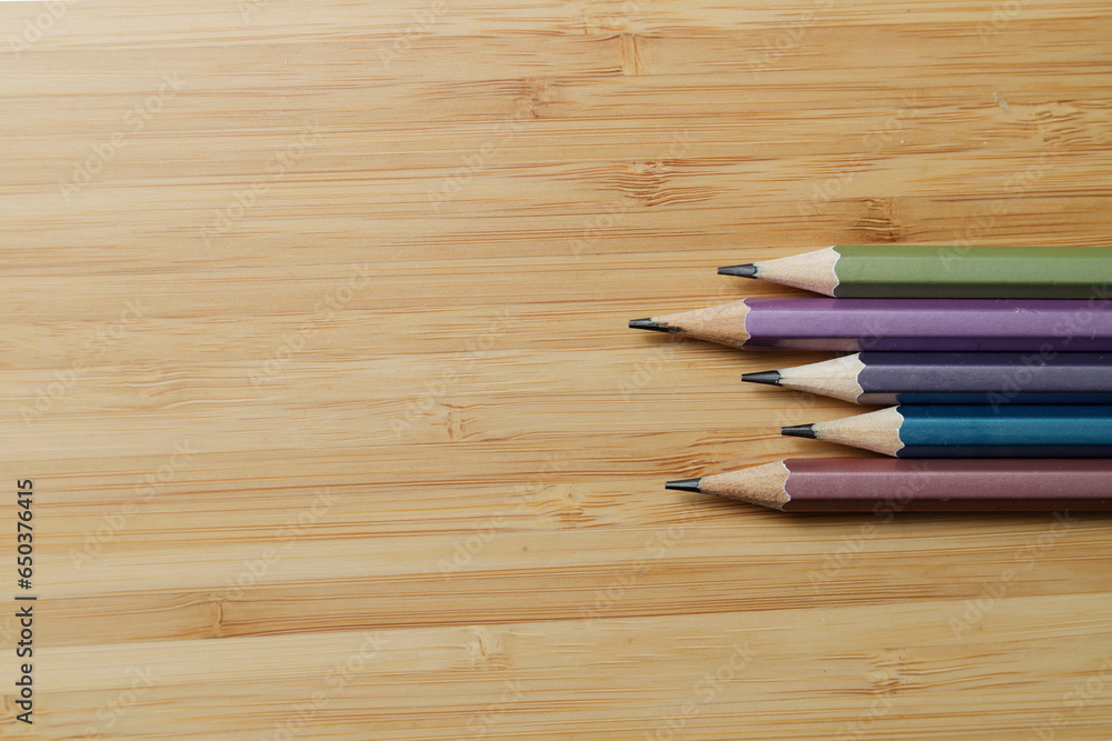 Obraz premium top view of various pencils on wood