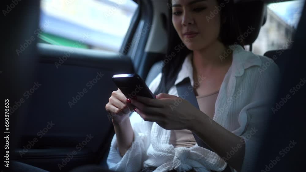 Relaxing feeling of woman sleeping back seats with safety belt and using smartphone in taxi car. Female happy in car while traveling on the road to your destination sitting in a taxi. Relaxing feeling of woman sleeping back seats with safety belt and using smartphone in taxi car. Female happy in car while traveling on the road to your destination sitting in a taxi.