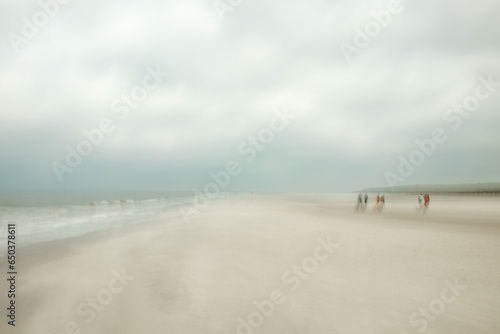 blurred photo of family on the beach