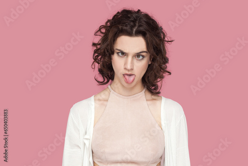 Εκτύπωση καμβά Portrait of crazy fool woman with curly hair wearing casual style outfit having foolish facial expression, grimacing, showing bad manners