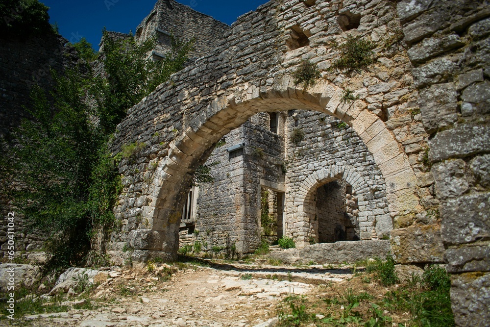 stone arch and door in the corner of an old ruin