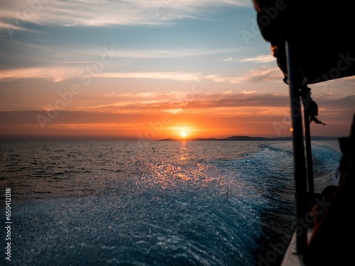 a sunset seen from a boat as it is going down the ocean