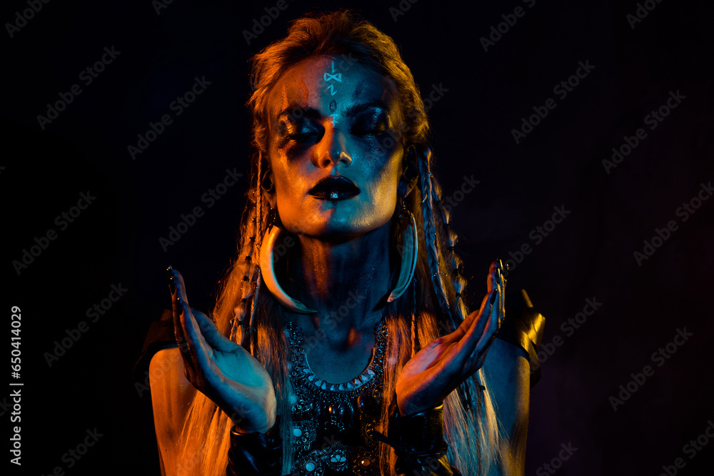 Photo of scandinavian mythology viking shaman girl bodyart pray oden ritual isolated on black background