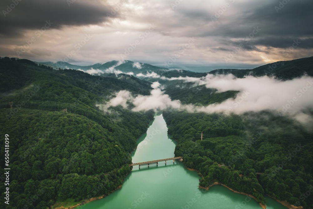 Fototapeta premium Aerial view of a tranquil landscape with river winding through it under the sunlit morning sky