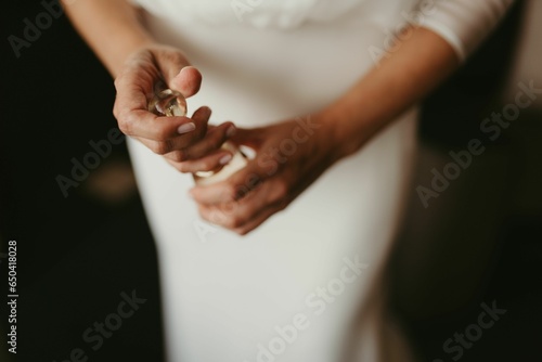 Woman is wearing a white half-sleeve wedding dress with buttons along the sleeves