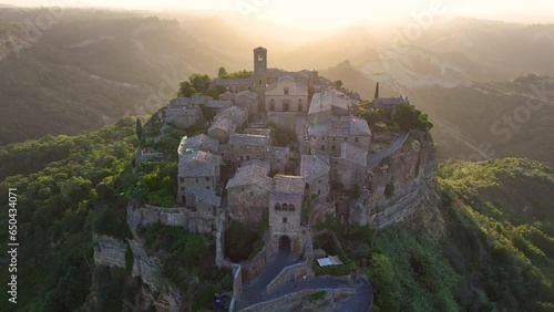 Civita di Bagnoregio, aerial view at sunrise, located on top of a volcanic tuff hill overlooking the Tiber river valley, province of Viterbo, Lazio, Italy