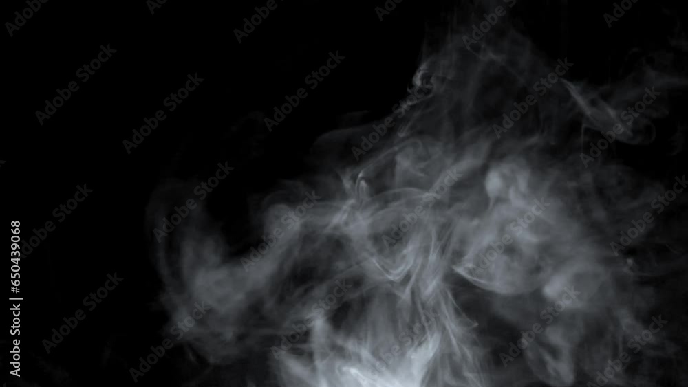 Smoke. Cloud of cold fog in blue light spot on black background. Abstract white smoke in slow motion. Light, white, fog, cloud, abstract, smoke, black, background, 4k, ice smoke cloud. Floating fog. Smoke. Cloud of cold fog in blue light spot on black background. Abstract white smoke in slow motion. Light, white, fog, cloud, abstract, smoke, black, background, 4k, ice smoke cloud. Floating fog.
