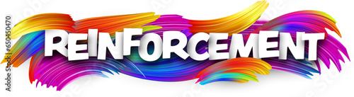 Reinforcement paper word sign with colorful spectrum paint brush strokes over white.