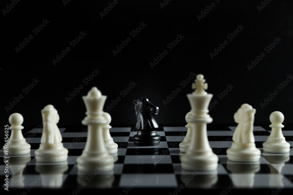 Pieces on chess board on black background for playing game and strategy. Pieces on chess board on black background for playing game and strategy.