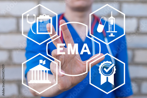 Doctor using virtual touch screen sees acronym: EMA. Concept of EMA European Medicines Agency. Department of medicines evaluation, drugs quality control and medical standards compliance.